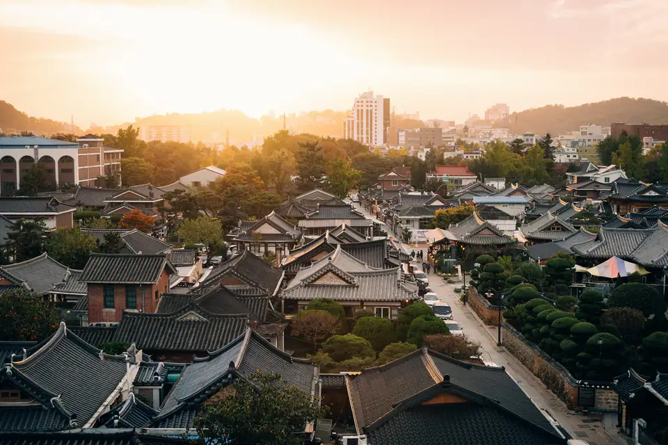 Curved tile roofs of the hanok village at sunset — Jeonju Hanok Village