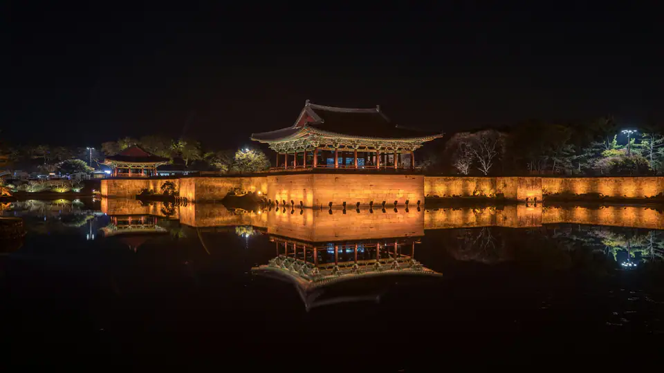 Palace pavilions lit at night beside the pond — Donggung Palace and Wolji Pond, Gyeongju