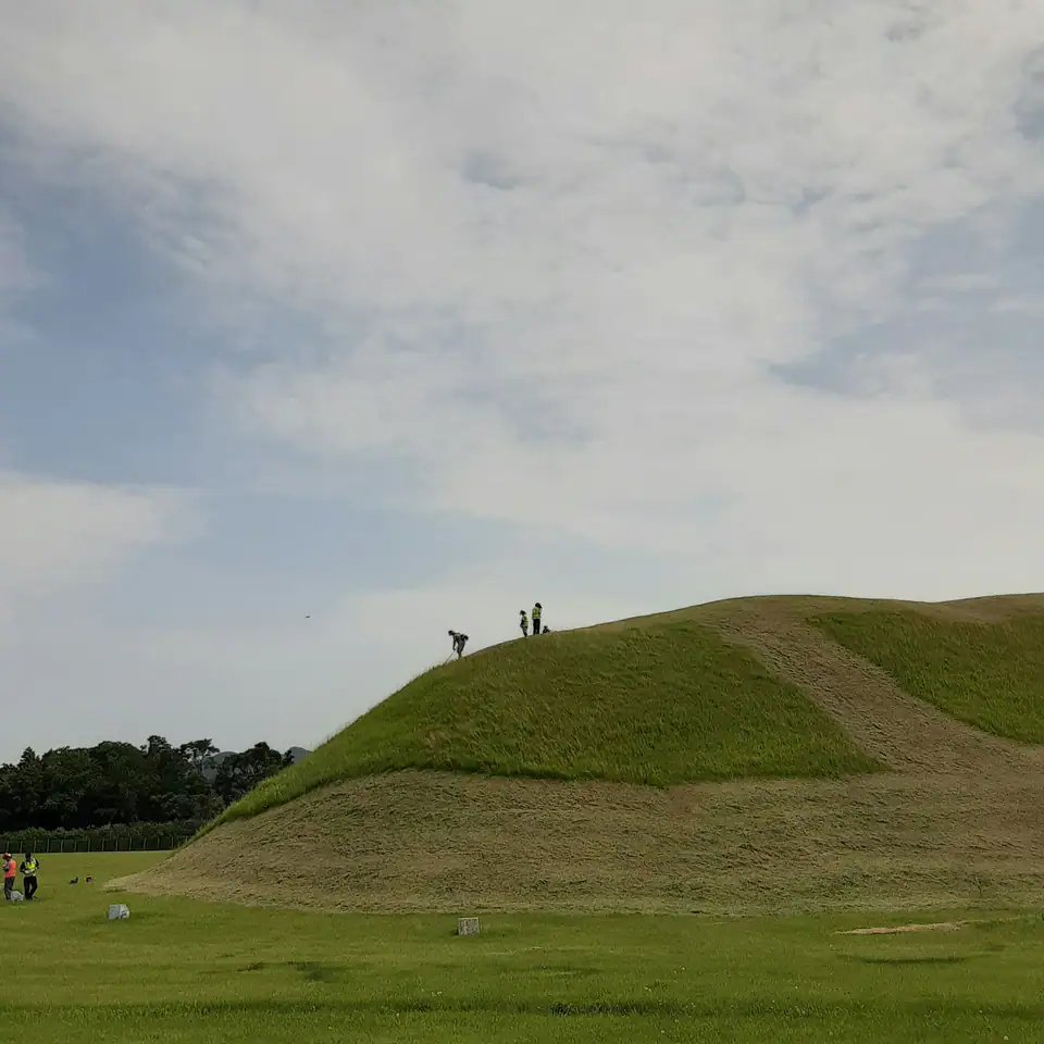 Grass-covered mounds with people walking beside them — Burial mounds, Gyeongju