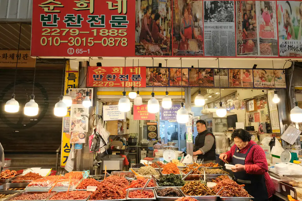 A market food stall with dishes laid out — Gwangjang Market, Seoul